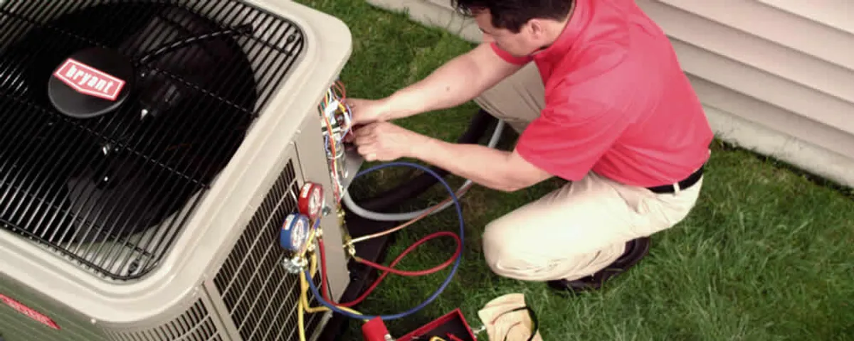HVAC technician servicing an outdoor air conditioner unit in Royal Oak, MI